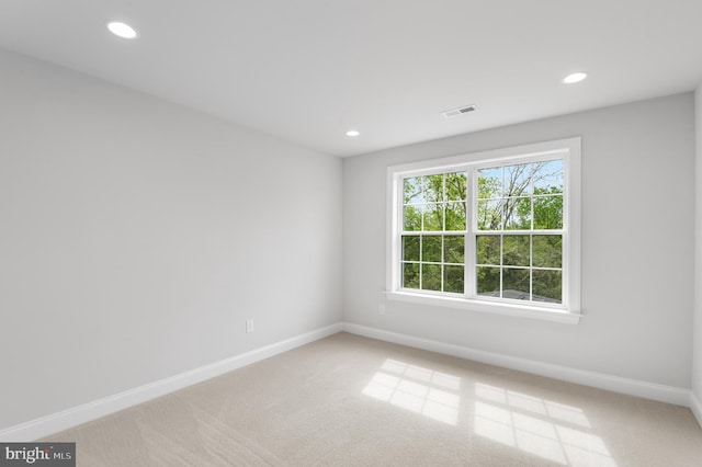 empty room featuring carpet floors, baseboards, and recessed lighting