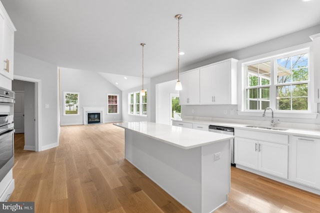 kitchen with plenty of natural light, sink, and white cabinets