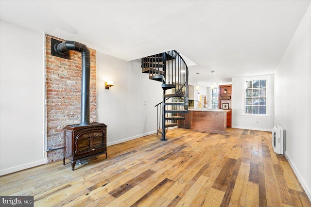 living room with light wood-type flooring and a wood stove