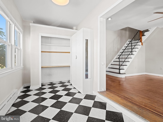 corridor featuring dark hardwood / wood-style floors and a baseboard radiator