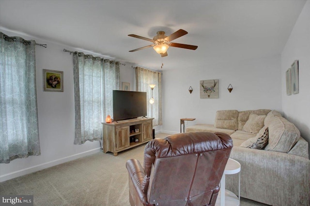 carpeted living room with ceiling fan