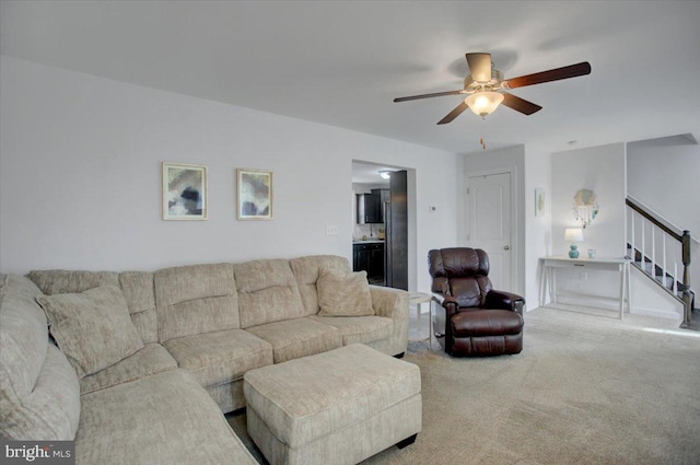 living room with ceiling fan and carpet