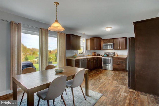 dining space with sink, plenty of natural light, and light hardwood / wood-style floors