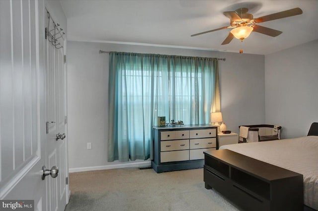 bedroom featuring light colored carpet and ceiling fan