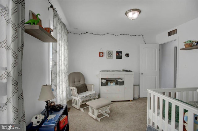 carpeted bedroom with a nursery area