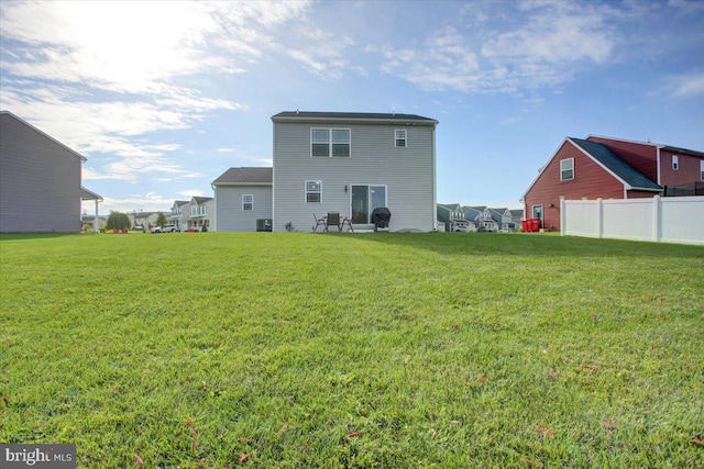 rear view of house featuring a lawn