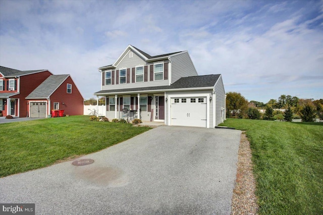 view of front of home with a garage, a front yard, and covered porch