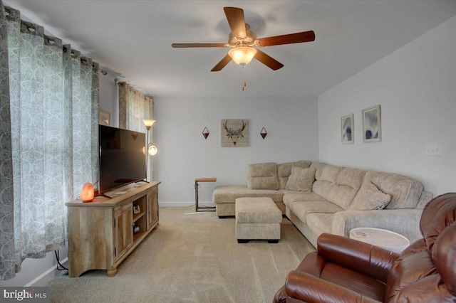 carpeted living room featuring ceiling fan