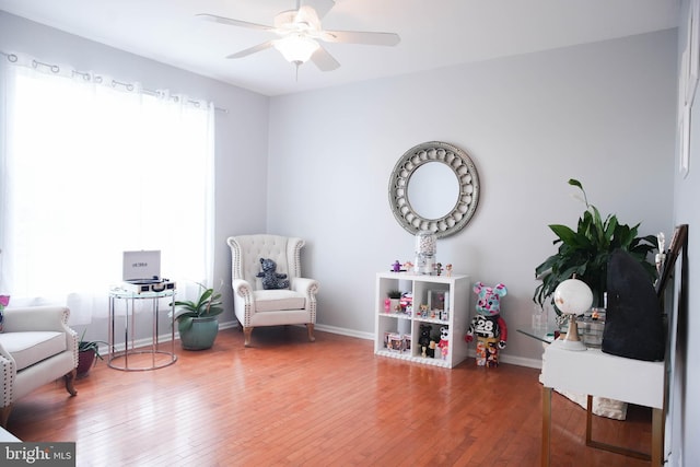 sitting room featuring hardwood / wood-style floors and ceiling fan