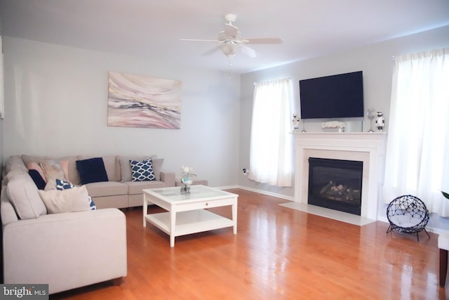 living room with hardwood / wood-style floors and ceiling fan