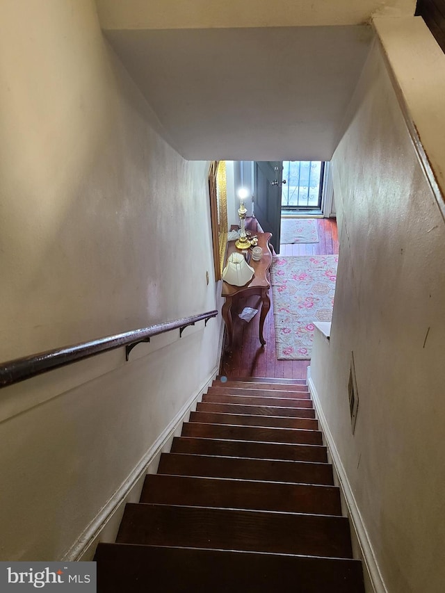 stairs with hardwood / wood-style flooring