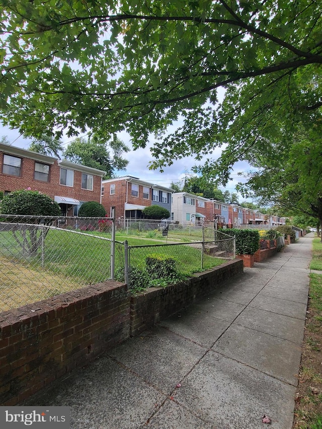 view of home's community with a lawn