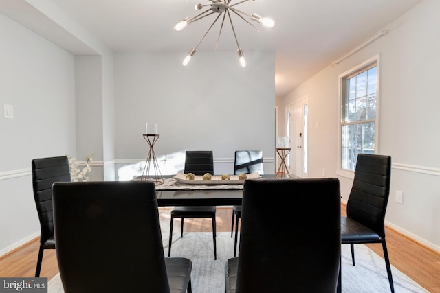 dining room featuring a chandelier and light hardwood / wood-style flooring