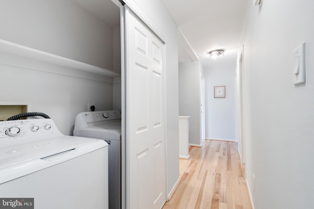 laundry room featuring light hardwood / wood-style floors and washer and clothes dryer