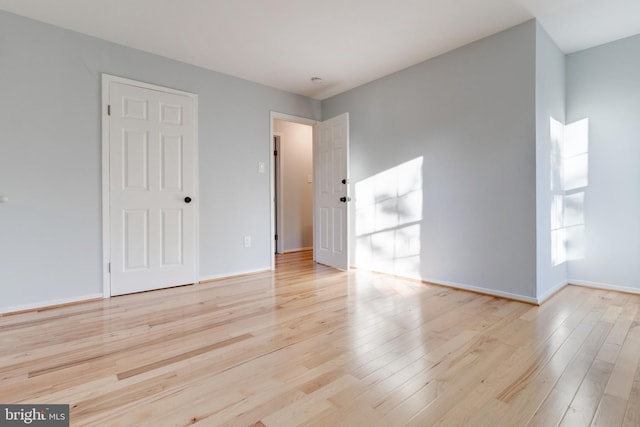 empty room with light hardwood / wood-style floors