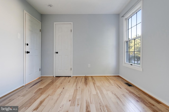 unfurnished room with light hardwood / wood-style flooring