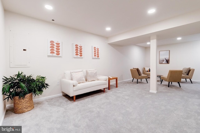 living area with electric panel and light colored carpet