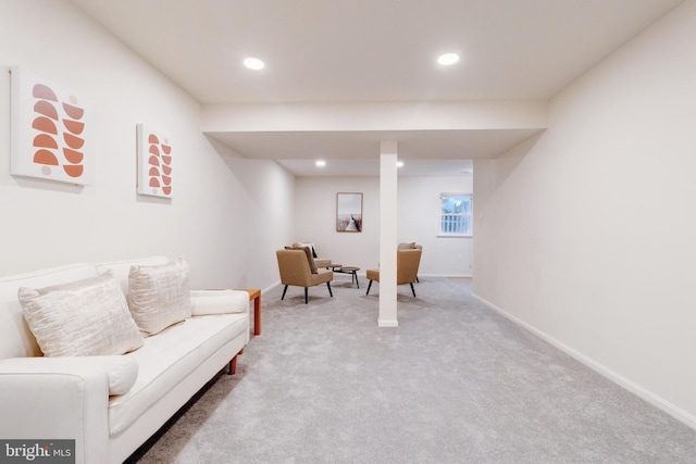 living area featuring light carpet