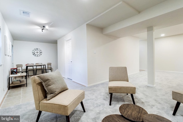 sitting room featuring light carpet