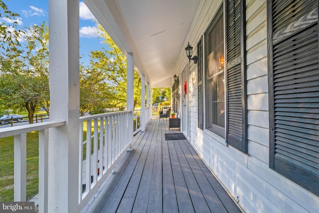 wooden terrace featuring covered porch