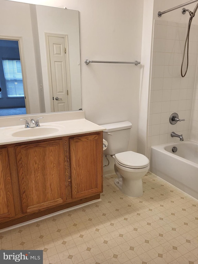 full bathroom with vanity, tiled shower / bath combo, and toilet