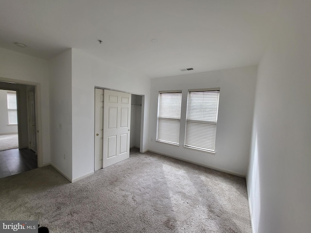 unfurnished bedroom featuring a closet and carpet