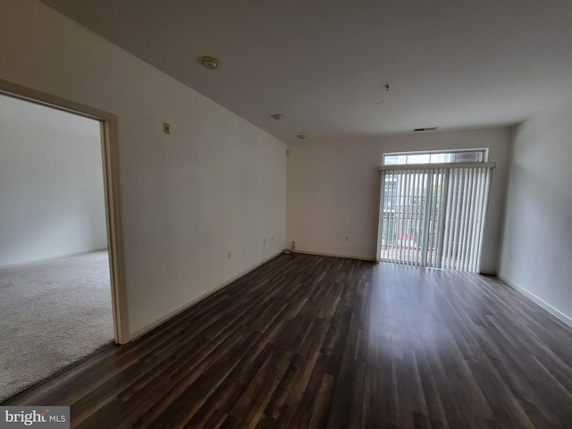 spare room with dark hardwood / wood-style floors