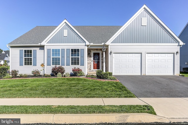 view of front facade with a front yard and a garage