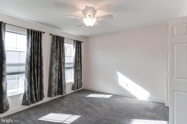 carpeted spare room featuring ceiling fan