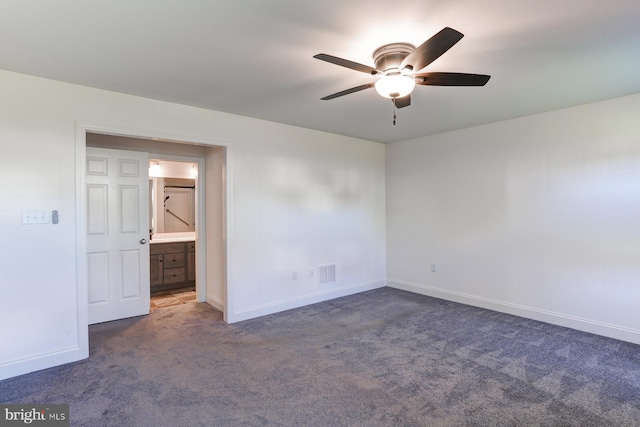 unfurnished bedroom featuring ceiling fan and dark carpet