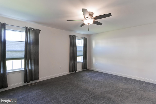 carpeted spare room featuring ceiling fan