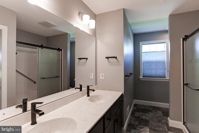 bathroom with vanity and a shower with shower door