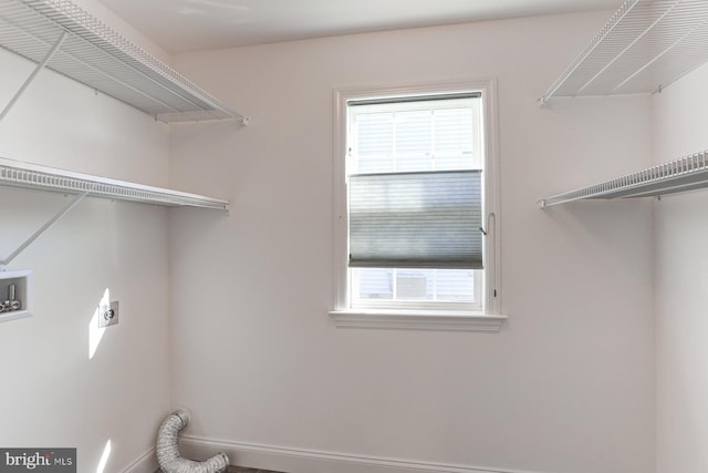 washroom featuring washer hookup, electric dryer hookup, and a healthy amount of sunlight