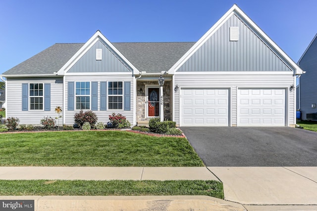 view of front of house with a front lawn and a garage