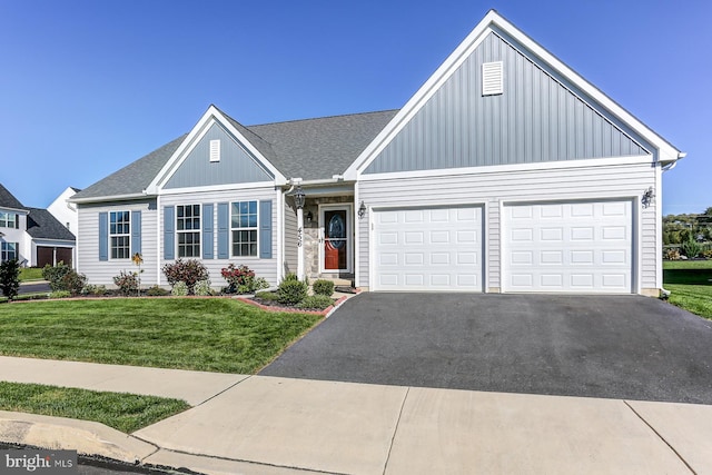 view of front of home featuring a garage and a front lawn