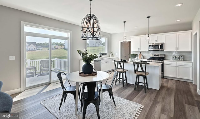 dining room featuring a chandelier, dark hardwood / wood-style floors, and sink