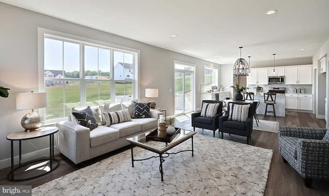 living room with dark hardwood / wood-style flooring and a wealth of natural light