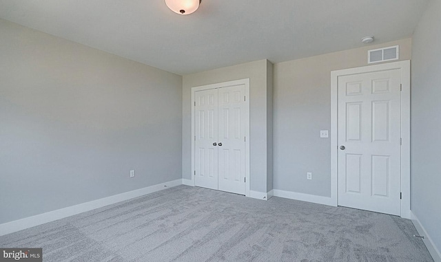 unfurnished bedroom with carpet flooring and a closet