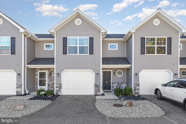 townhome / multi-family property featuring a garage