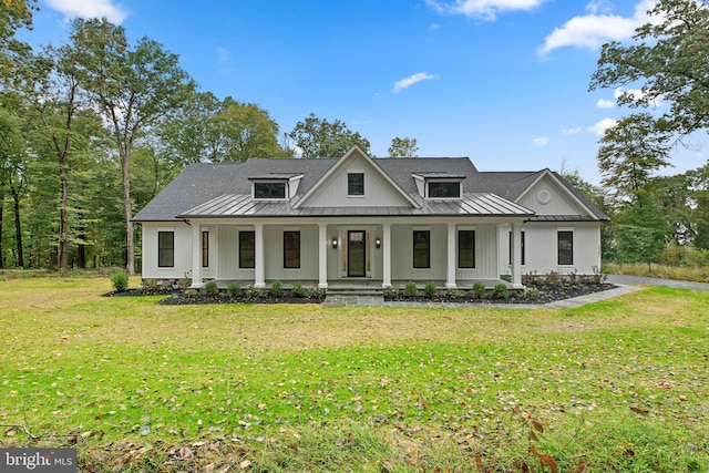 modern farmhouse style home featuring a front lawn and a porch