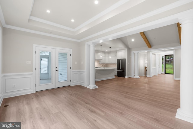 unfurnished living room with french doors, light hardwood / wood-style floors, ornamental molding, and a wealth of natural light