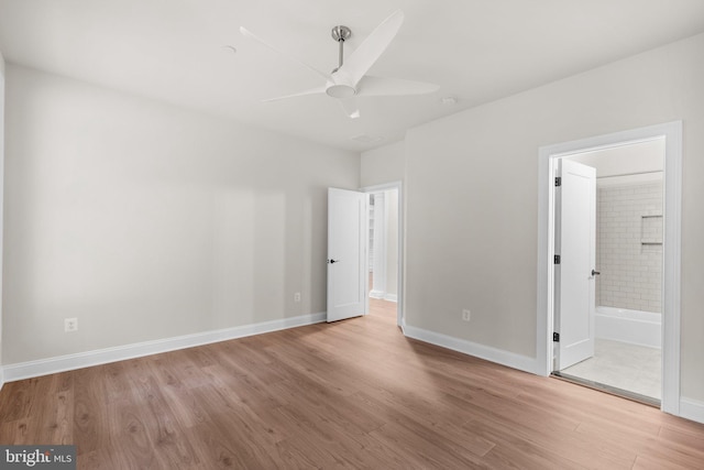 unfurnished bedroom featuring light hardwood / wood-style flooring, ceiling fan, and ensuite bath