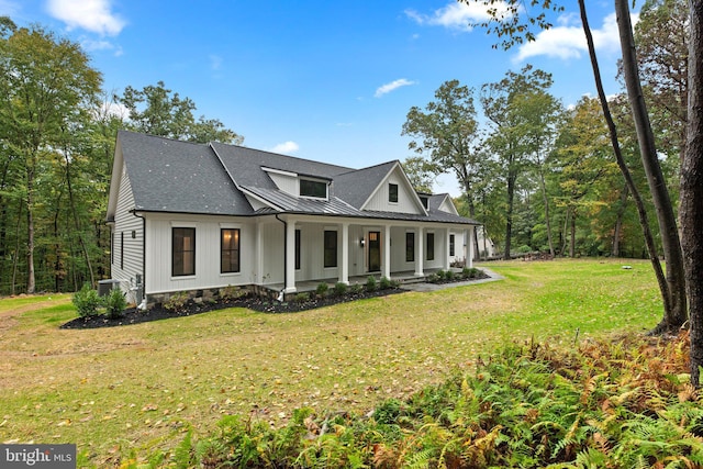 modern farmhouse featuring cooling unit and a front lawn