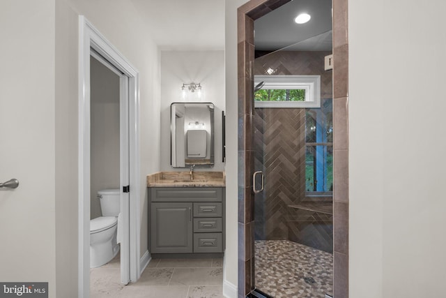 bathroom featuring vanity, toilet, and an enclosed shower