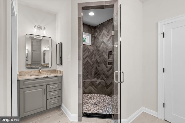 bathroom featuring vanity, tile patterned floors, and walk in shower