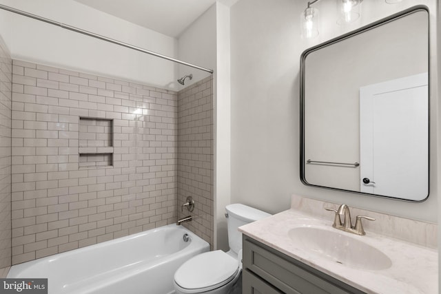 full bathroom featuring toilet, tiled shower / bath combo, and vanity