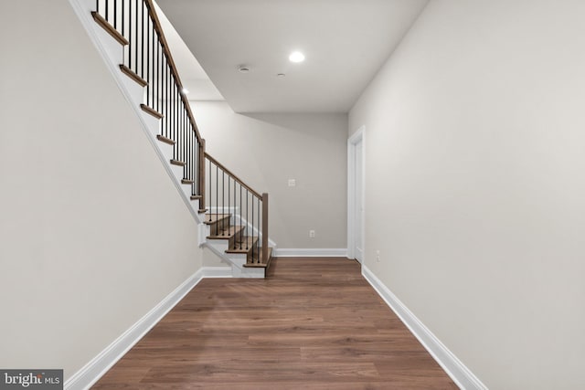 stairs with hardwood / wood-style floors