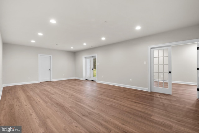 empty room featuring light hardwood / wood-style floors and french doors