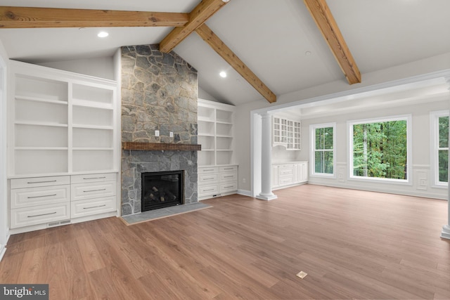 unfurnished living room featuring lofted ceiling with beams, light hardwood / wood-style flooring, and a fireplace