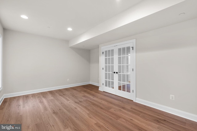 unfurnished room with french doors and light hardwood / wood-style floors